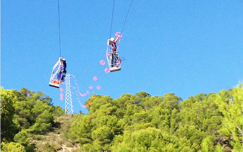 flight diverters being put up by 2 engineers from Red Electrica, Spain